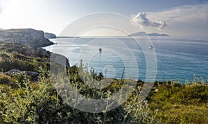 Landscape with rocky coast and bay at sunset