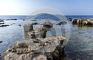 A landscape with a rocky coast in the evening