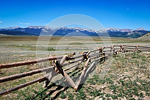 Landscape of Rocky Mountains with log fence