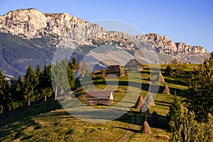 Landscape from Romania with haystack and old wooden house in the mountain of Transylvania