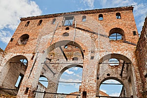 Landscape of ruined buildings at sunset, image of decrepitude or natural disaster.