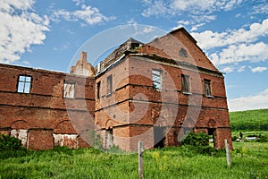 Landscape of ruined buildings at sunset, image of decrepitude or natural disaster.