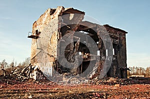 Landscape of ruined buildings at sunset, image of decrepitude or natural disaster