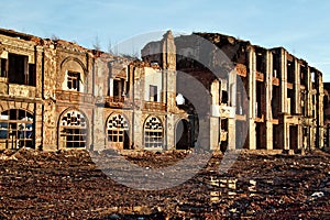 Landscape of ruined buildings at sunset, image of decrepitude or natural disaster