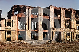 Landscape of ruined buildings at sunset, image of decrepitude or natural disaster