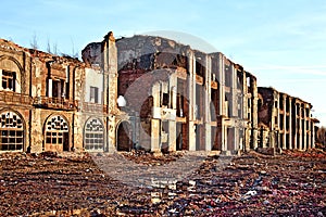 Landscape of ruined buildings at sunset, image of decrepitude or natural disaster