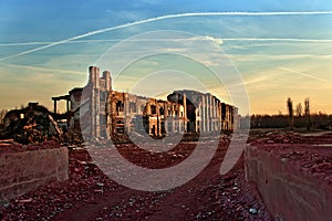 Landscape of ruined buildings at sunset, image of decrepitude or natural disaster