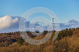 Landscape of a rural region with trees and forest in front of a wind turbine, Baden-Wuerttemberg