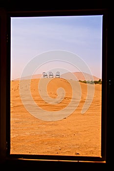 Landscape of the sand dunes framed by the window in Sahara Desert, Morocco