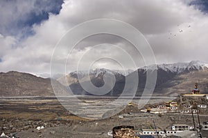 Landscape and sandstorm cyclone with 32 metre statue of Maitreya Buddha near Diskit Monastery at nubra village at Leh Ladakh India