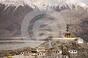 Landscape and sandstorm cyclone with 32 metre statue of Maitreya Buddha near Diskit Monastery at nubra village at Leh Ladakh India