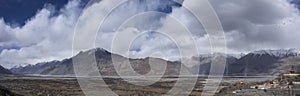 Landscape and sandstorm cyclone with 32 metre statue of Maitreya Buddha near Diskit Monastery at nubra village at Leh Ladakh India