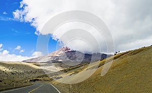 Landscape with scenic road and Chimborazo volcano shrouded in the clouds, Ecuador