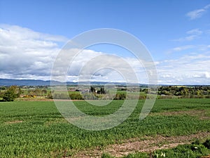 Landscape of Scotland - fields of green crops, mountains and blue sky