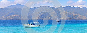 Landscape of sea with boats of island Gili Trawangan. Sea bay with mountains, Bali, Indonesia photo