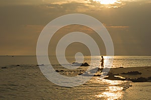 Landscape of sea and cloudy sky which has sun beam shine on sea water and beach in morning