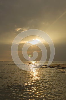 Landscape of sea and cloudy sky which has sun beam shine on sea water and beach in morning