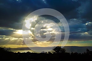 Landscape of the Sea Galilee - Sea of Galilee. Rain clouds above the lake. The sun`s rays break through the clouds