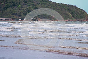 Landscape sea with many waves breaking on sandy shore in the evening