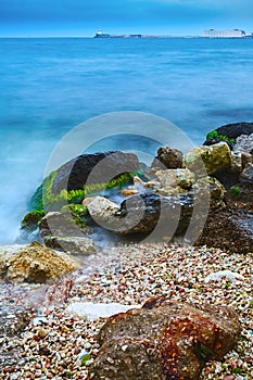 Landscape of the sea shore with a long exposure. The stones of g