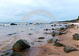 Landscape with sea shore, rocks in water and sand, December, Vidzeme rocky seashore, Latvia