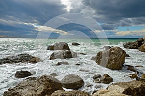 Landscape on the sea, surf on the rocky shore with stormy sky, Crimea