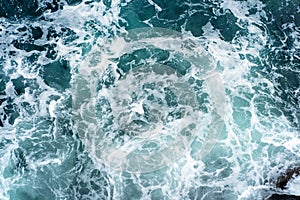 Landscape of sea waves and foam breaking on rocks