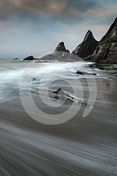 Landscape seascape of jagged and rugged rocks on coastline with