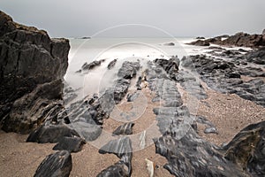 Landscape seascape of jagged and rugged rocks on coastline with