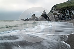 Landscape seascape of jagged and rugged rocks on coastline with