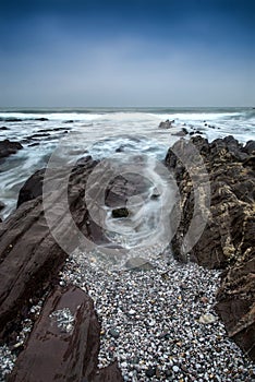Landscape seascape of jagged and rugged rocks on coastline with