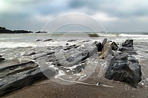 Landscape seascape of jagged and rugged rocks on coastline with