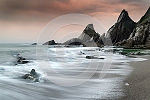 Landscape seascape of jagged and rugged rocks on coastline with