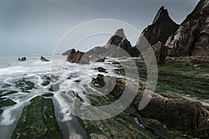 Landscape seascape of jagged and rugged rocks on coastline with