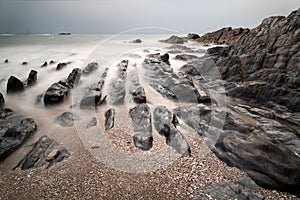 Landscape seascape of jagged and rugged rocks on coastline with