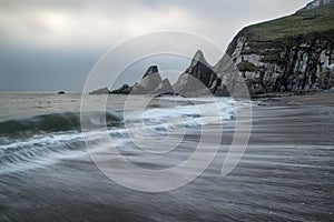 Landscape seascape of jagged and rugged rocks on coastline with