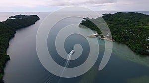 Landscape and Seascape of Koror island in Palau. Boat and Meyungs island in Background