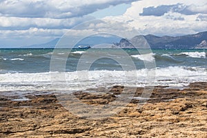 landscape seaside storm ships on the horizon and rocks