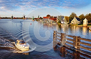 Landscape with ship and watermills in Netherlands