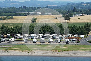 Landscape and shoreline with caravan cars and camping van  parked in riverside of Columbia river.