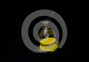 Landscape shot of a broken hourglass with a pitch-black background