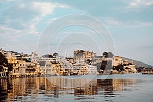 Landscape shot of the city of lakes with buildings reflecting on the water in Nathdwara, India