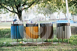 Landscape shot of colorful garbage bins outside promoting clean environment