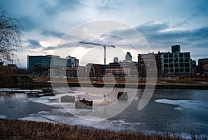 Landscape shot of the Lachine Canal buildings in the background on cloudy day in Montreal, Canada