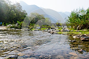 Landscape shot with small river hills and sunlight during morning