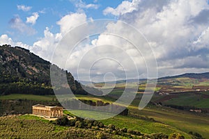 Landscape of Sicily and ancient greek temple in Segesta archaeological area, Italy.