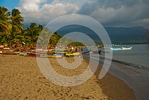 Landscape sky with clouds, volcanic sand on the beach. Pandan, Panay, Philippines.