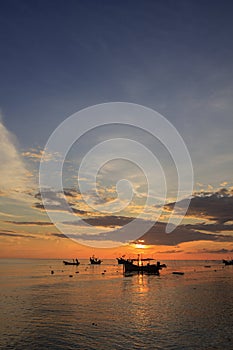 Landscape of sky and sea which has group of small fishing boat at dawn