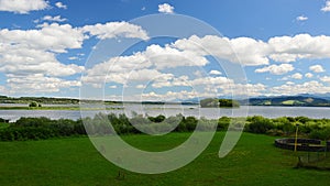 Landscape with Slanica Island Of Art in center of Orava river dam in northern Slovakia covered with mostly broadleaf trees