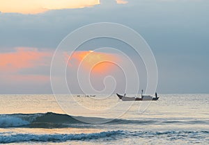 Landscape of small fishing boats of Vietnamese fishermen fishing at dawn in the sea